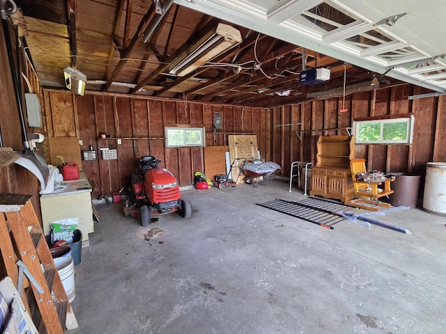 3803 State Highway 147 W, Two Rivers, WI 54241 - garage featuring a garage door opener and wood walls