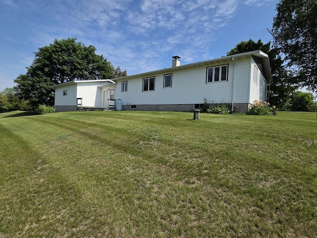 3803 State Highway 147 W, Two Rivers, WI 54241 - back of house featuring entry steps, a lawn, and a chimney