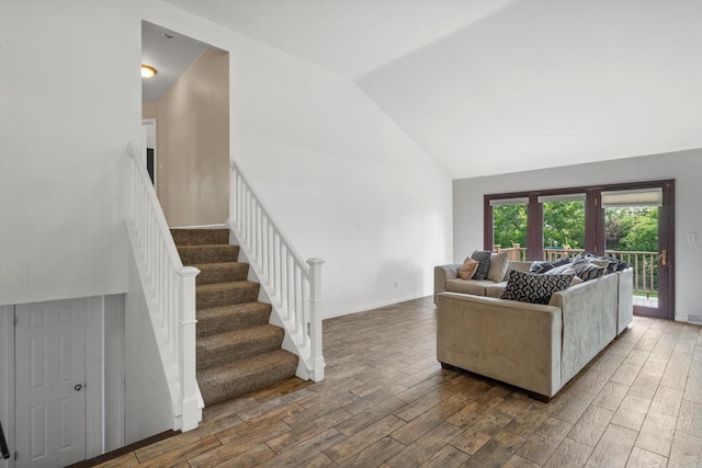 6650 N 114th St, Milwaukee, WI 53224 - living room featuring wood finished floors, stairs, high vaulted ceiling, and baseboards