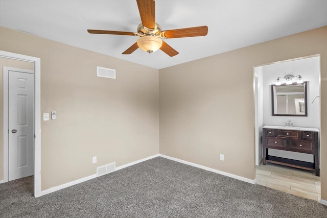 6650 N 114th St, Milwaukee, WI 53224 - unfurnished bedroom with carpet flooring, baseboards, a ceiling fan, and connected bathroom