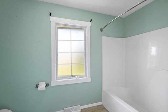 6650 N 114th St, Milwaukee, WI 53224 - bathroom featuring healthy amount of natural light, baseboards, and shower / bathtub combination