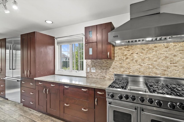 6650 N 114th St, Milwaukee, WI 53224 - kitchen featuring wall chimney range hood, double oven range, light stone counters, tasteful backsplash, and recessed lighting