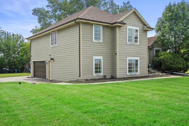 6650 N 114th St, Milwaukee, WI 53224 - view of side of home with concrete driveway, a garage, a yard, and a shingled roof