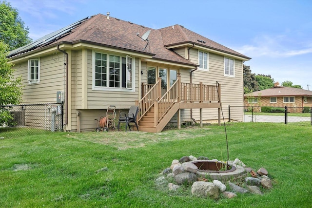 6650 N 114th St, Milwaukee, WI 53224 - back of property featuring a fire pit, stairway, solar panels, a shingled roof, and a wooden deck