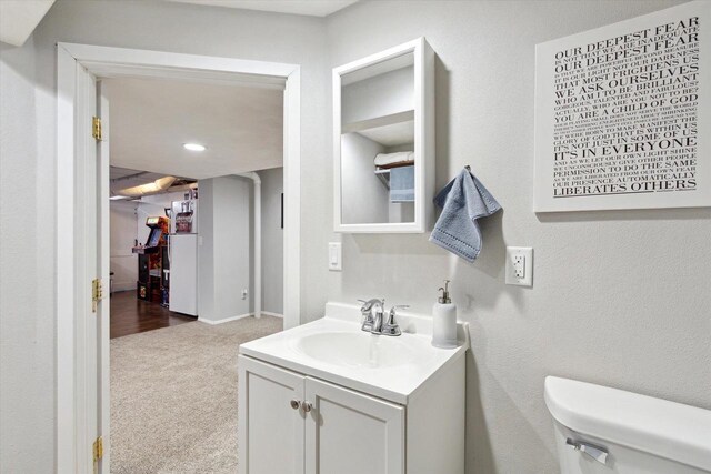 4441 N John Paul Rd, Milton, WI 53546 - bathroom featuring vanity, toilet, and recessed lighting