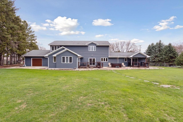 4441 N John Paul Rd, Milton, WI 53546 - back of house with an attached garage, a lawn, a deck, and a patio area