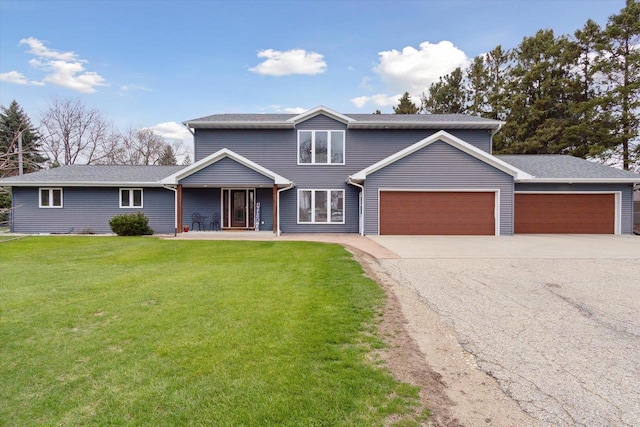 4441 N John Paul Rd, Milton, WI 53546 - traditional-style house with a garage, asphalt driveway, and a front yard