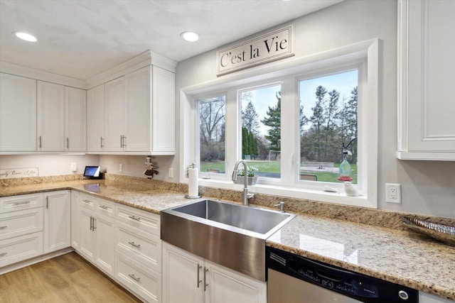 4441 N John Paul Rd, Milton, WI 53546 - kitchen featuring a sink, stainless steel dishwasher, white cabinets, light stone countertops, and light wood-type flooring