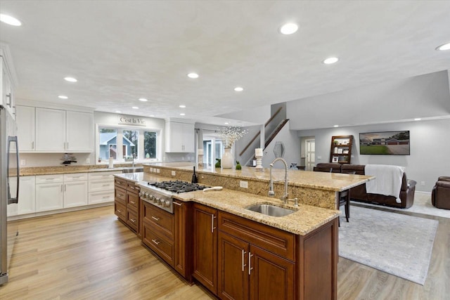 4441 N John Paul Rd, Milton, WI 53546 - kitchen with a sink, gas cooktop, open floor plan, light wood-style floors, and recessed lighting
