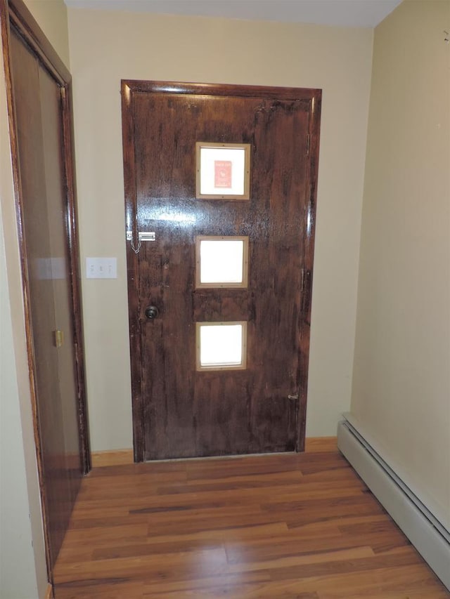 422 E Catherine St, Muscoda, WI 53573 - foyer entrance featuring a baseboard heating unit and wood finished floors