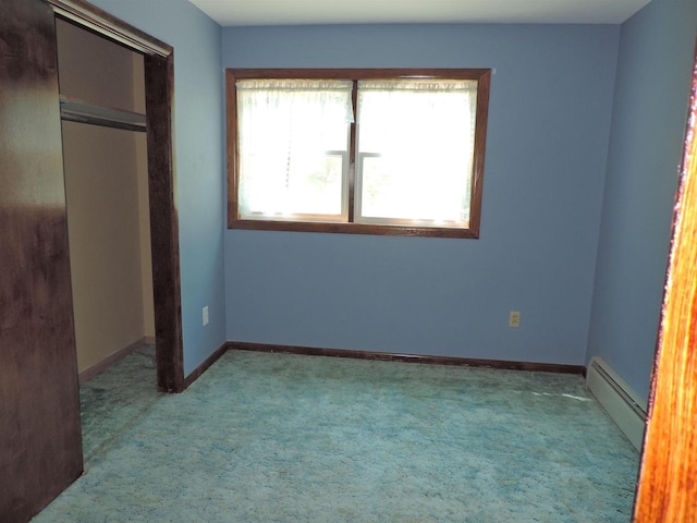 422 E Catherine St, Muscoda, WI 53573 - unfurnished bedroom with a baseboard heating unit, carpet, a closet, and baseboards