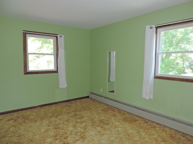422 E Catherine St, Muscoda, WI 53573 - empty room featuring a baseboard radiator, healthy amount of natural light, and carpet floors