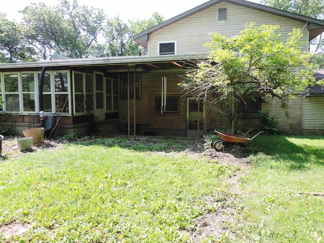 422 E Catherine St, Muscoda, WI 53573 - back of property featuring a sunroom and a lawn