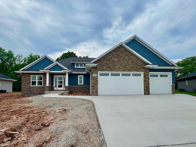 3566 W Hank Ave, De Pere, WI 54115 - craftsman-style house with stone siding, concrete driveway, and a garage