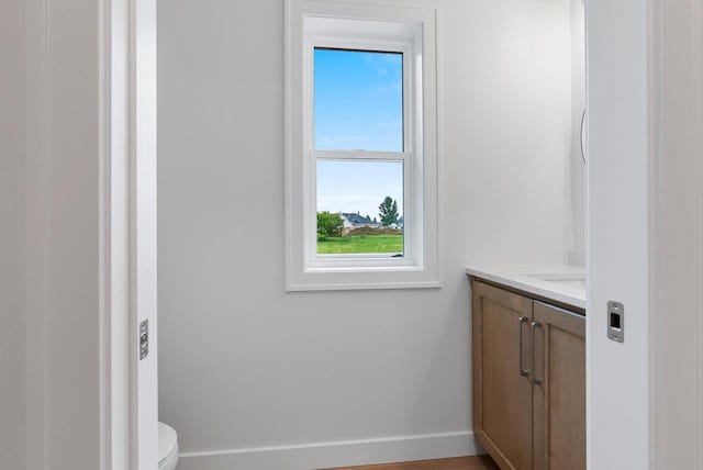 3566 W Hank Ave, De Pere, WI 54115 - half bathroom with vanity, toilet, and baseboards