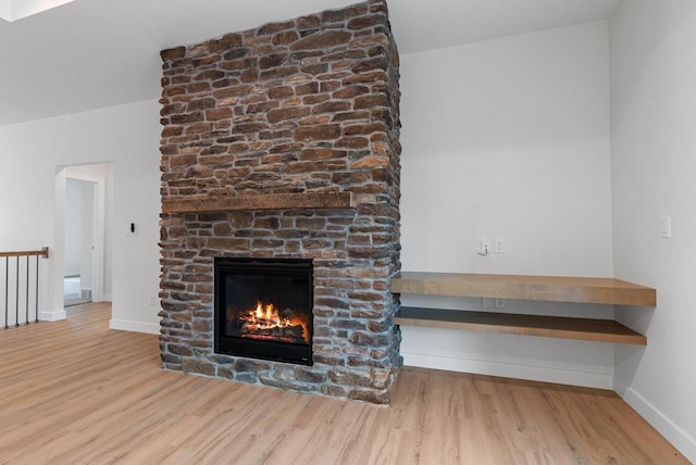 3566 W Hank Ave, De Pere, WI 54115 - unfurnished living room with wood finished floors, baseboards, and a stone fireplace