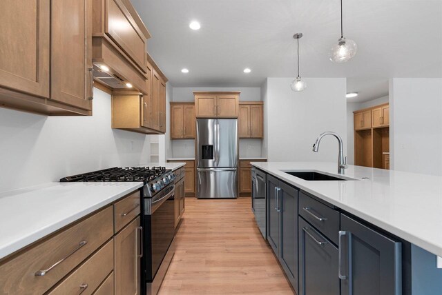 3566 W Hank Ave, De Pere, WI 54115 - kitchen with stainless steel fridge, range with gas stovetop, a sink, light wood-style flooring, and light countertops