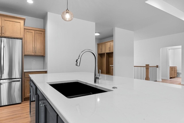 3566 W Hank Ave, De Pere, WI 54115 - kitchen featuring freestanding refrigerator, a sink, decorative light fixtures, light wood finished floors, and recessed lighting