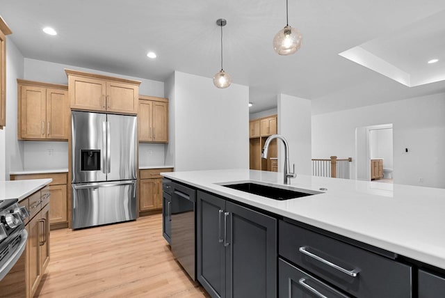 3566 W Hank Ave, De Pere, WI 54115 - kitchen with appliances with stainless steel finishes, a sink, light countertops, pendant lighting, and light wood-style flooring