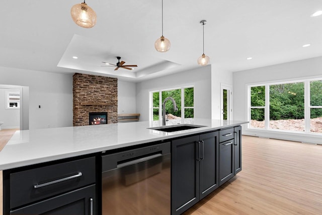 3566 W Hank Ave, De Pere, WI 54115 - kitchen featuring stainless steel dishwasher, a sink, open floor plan, light countertops, and ceiling fan