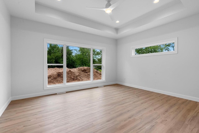 3566 W Hank Ave, De Pere, WI 54115 - empty room featuring a raised ceiling, light wood-style floors, baseboards, recessed lighting, and ceiling fan