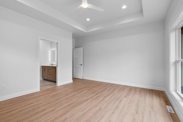 3566 W Hank Ave, De Pere, WI 54115 - unfurnished bedroom with light wood-style flooring, a tray ceiling, baseboards, and recessed lighting