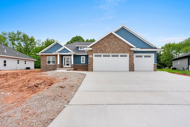 3566 W Hank Ave, De Pere, WI 54115 - craftsman inspired home with board and batten siding, a garage, concrete driveway, and stone siding
