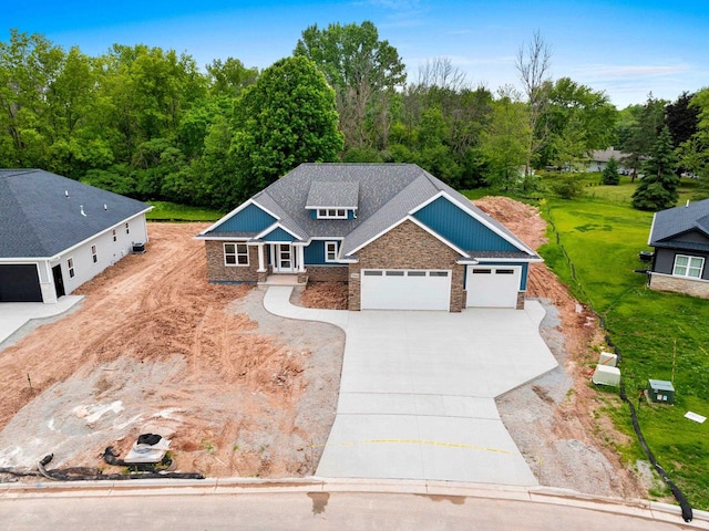 3566 W Hank Ave, De Pere, WI 54115 - view of front of home with stone siding, driveway, and a garage