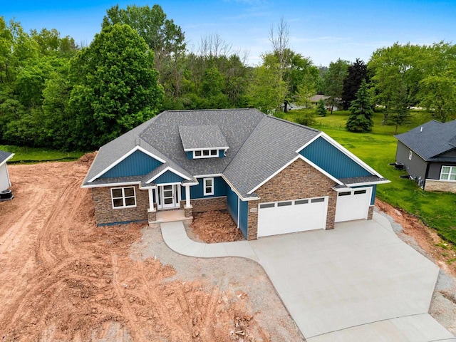 3566 W Hank Ave, De Pere, WI 54115 - craftsman inspired home with stone siding, driveway, an attached garage, and roof with shingles