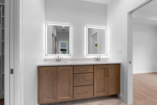 3566 W Hank Ave, De Pere, WI 54115 - full bath with double vanity, baseboards, and wood finished floors