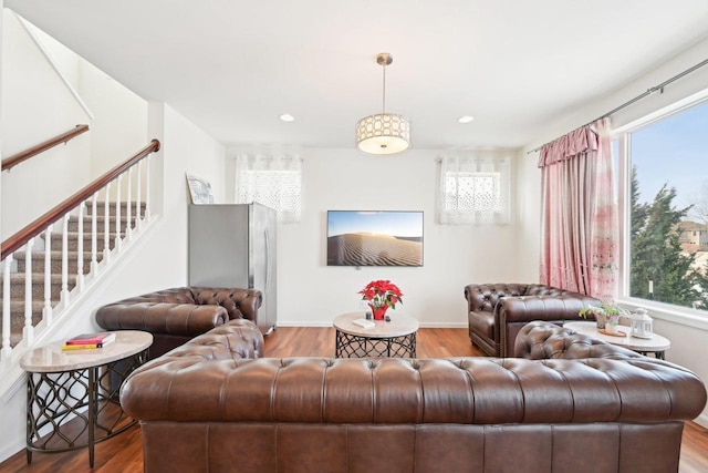 2418 Leopold Way, Sun Prairie, WI 53590 - living area with plenty of natural light, stairs, wood finished floors, and recessed lighting