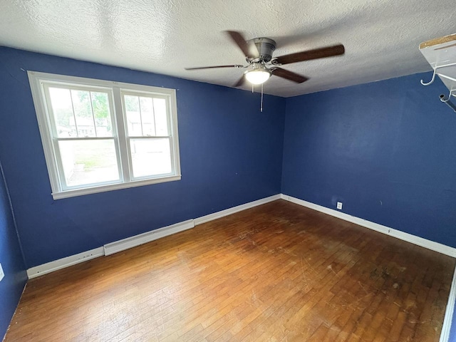 230 Park Ave, Wisconsin Rapids, WI 54495 - spare room with wood-type flooring, ceiling fan, a textured ceiling, and baseboards