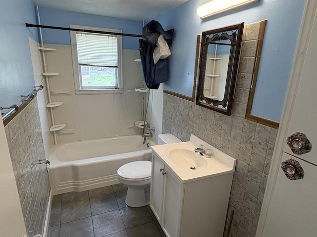 230 Park Ave, Wisconsin Rapids, WI 54495 - full bathroom featuring tile walls, toilet, a wainscoted wall, vanity, and shower / bathtub combination