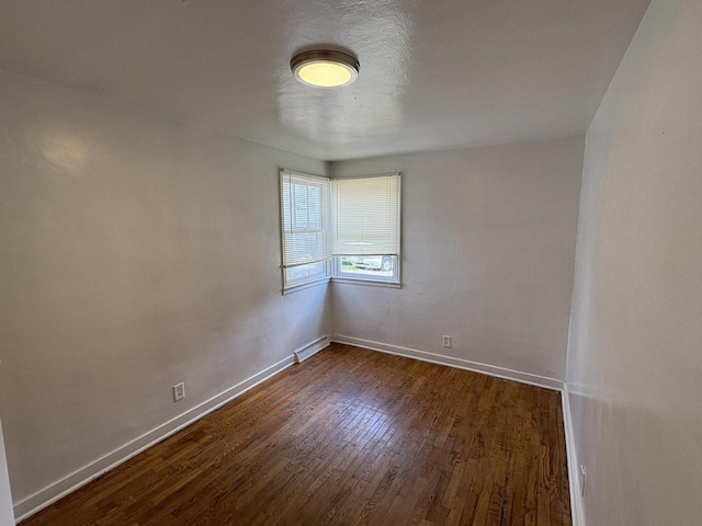 230 Park Ave, Wisconsin Rapids, WI 54495 - unfurnished room with baseboards and dark wood-style floors