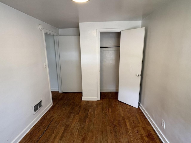 230 Park Ave, Wisconsin Rapids, WI 54495 - unfurnished bedroom with wood finished floors, a closet, and baseboards