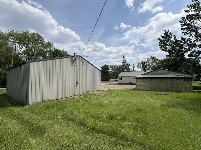 230 Park Ave, Wisconsin Rapids, WI 54495 - view of green lawn with driveway and an outdoor structure