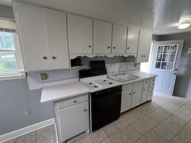 230 Park Ave, Wisconsin Rapids, WI 54495 - kitchen with a sink, electric range, light countertops, and white cabinets