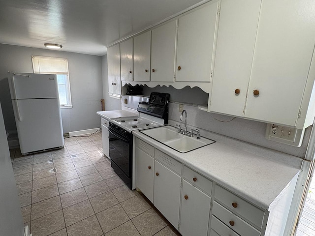 230 Park Ave, Wisconsin Rapids, WI 54495 - kitchen with freestanding refrigerator, black range with electric stovetop, a sink, light countertops, and light tile patterned floors