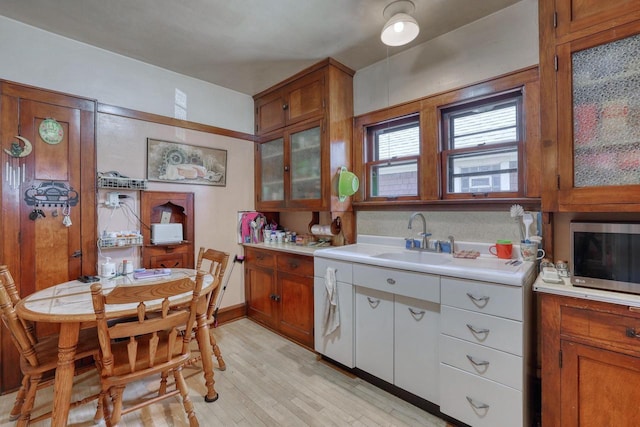 1107 S 71st St Unit 1109, West Allis, WI 53214 - kitchen featuring stainless steel microwave, light countertops, a sink, and brown cabinetry