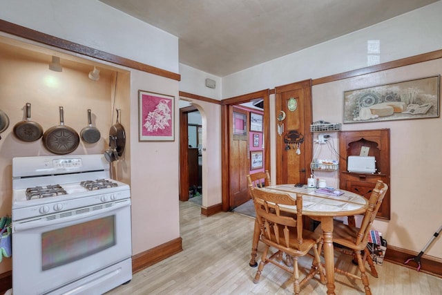 1107 S 71st St Unit 1109, West Allis, WI 53214 - dining space featuring arched walkways, light wood-style floors, and baseboards