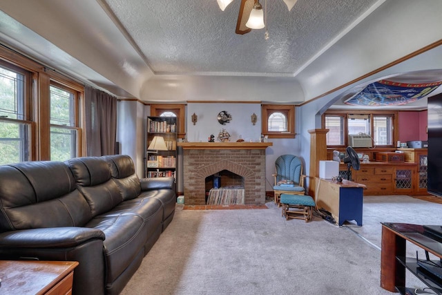 1107 S 71st St Unit 1109, West Allis, WI 53214 - living area with a textured ceiling, carpet floors, arched walkways, a ceiling fan, and a brick fireplace