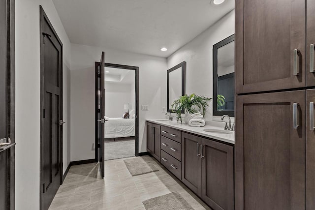 1338 Highland Ridge Dr, De Pere, WI 54115 - ensuite bathroom featuring double vanity, recessed lighting, and baseboards