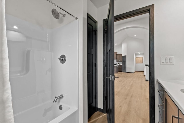 1338 Highland Ridge Dr, De Pere, WI 54115 - full bathroom featuring vanity, wood finished floors, shower / washtub combination, and recessed lighting