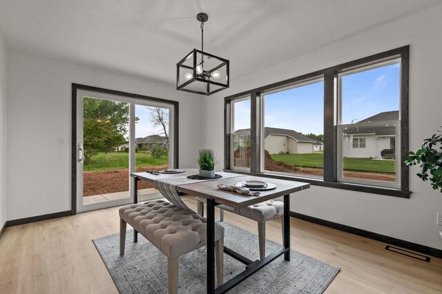 1338 Highland Ridge Dr, De Pere, WI 54115 - dining space with a chandelier, baseboards, and light wood-type flooring