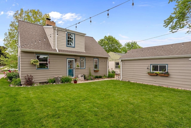 6619 W Fremont Pl, Milwaukee, WI 53219 - back of property featuring a yard, a chimney, and a shingled roof