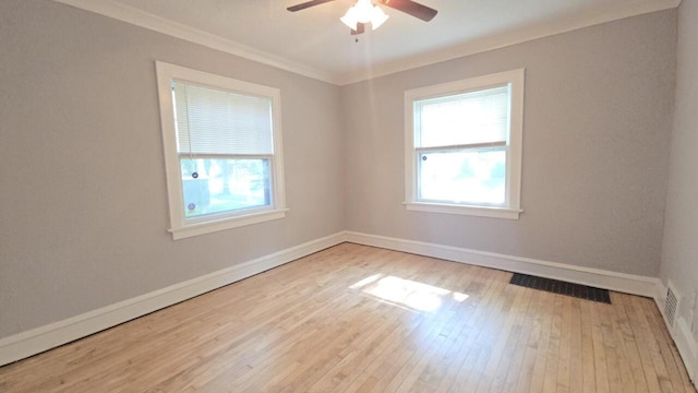 5415 N 36th St, Milwaukee, WI 53209 - empty room featuring healthy amount of natural light, a ceiling fan, wood finished floors, baseboards, and crown molding