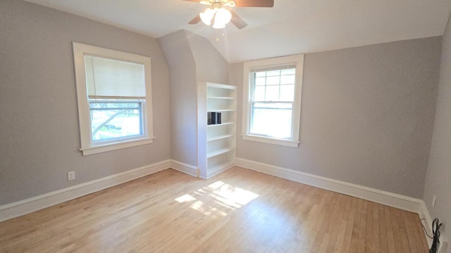 5415 N 36th St, Milwaukee, WI 53209 - unfurnished room with wood finished floors, vaulted ceiling, a ceiling fan, and baseboards