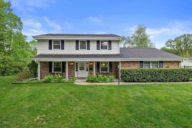 10309 Sherman Rd, Cedarburg, WI 53012 - traditional-style home with brick siding, a front lawn, and covered porch