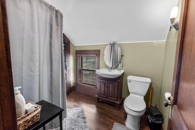 1439 Parkview Dr, Kewaskum, WI 53040 - full bathroom with lofted ceiling, wood finished floors, vanity, toilet, and curtained shower