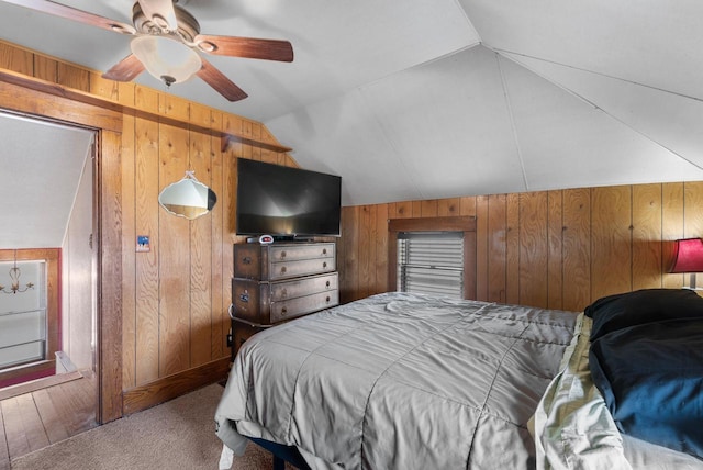 1439 Parkview Dr, Kewaskum, WI 53040 - carpeted bedroom with wood walls, lofted ceiling, and ceiling fan